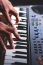 Music magician Playing the Electronic Keyboard in Music Recording studio close up on hands. Playing electronic Piano