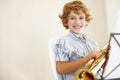 Music makes me smile. a cute little boy playing the trumpet. Royalty Free Stock Photo