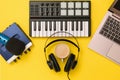 Music mixer,microphone, headphones and sound card on yellow background. The concept of workplace organization Royalty Free Stock Photo