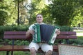 Music. Musician with harmonica or accordion