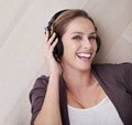 Music is my escape. Portrait of a beautiful woman listening to music over her headphones.