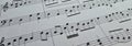 Music notes background. Musical concept macro view of white score sheet music Royalty Free Stock Photo