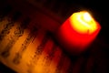 Music Notes Sheet in a Red Candle Light Royalty Free Stock Photo