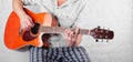 Music - Orange electric acoustic guitar player chord D white br Royalty Free Stock Photo