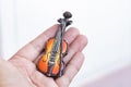 Music passion and hobby concept, hand holding violin miniature.copy space on the right for text