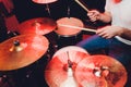 Music, people, musical instruments and entertainment concept - male musician or drummer playing drum kit at studio over holidays