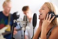 Music, performance and woman with microphone, headphones and singing band with talent. Recording studio, art and happy Royalty Free Stock Photo