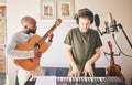 Music, piano and friends with guitar recording in home studio together. Electric keyboard, instrument and microphone of Royalty Free Stock Photo