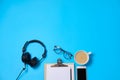 Music or podcast background with headphones, microphone, coffee and blank on blue table, flat lay. Top view, flat lay Royalty Free Stock Photo