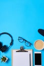 Music or podcast background with headphones, microphone, coffee and blank on blue table, flat lay. Top view, flat lay Royalty Free Stock Photo