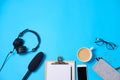 Music or podcast background with headphones, microphone, coffee and blank on blue table, flat lay. Top view, flat lay Royalty Free Stock Photo