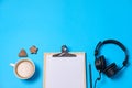 Music or podcast background with headphones, microphone, coffee and blank on blue table, flat lay. Top view, flat lay Royalty Free Stock Photo