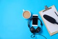 Music or podcast background with headphones, microphone, coffee and blank on blue table, flat lay. Top view, flat lay Royalty Free Stock Photo