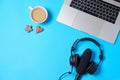 Music or podcast background with headphones, microphone, coffee and laptop on blue table, flat lay. Top view, flat lay Royalty Free Stock Photo