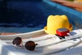 Music portable speaker is charged from the power bank via usb on a deck chair near the pool with beach accessories. Royalty Free Stock Photo