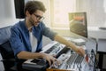 Music producer is composing a song on synthesizer keyboard and computer in recording studio. Man is working on sound Royalty Free Stock Photo