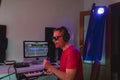 Music producer singing during a recording session at his home studio