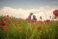 music. romantic couple with guitar in poppy flowers. family summer vacation. happy man and woman in love enjoy spring Royalty Free Stock Photo