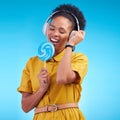 Music, singer and lollipop with black woman and headphones for streaming, audio and media. Radio, technology and freedom