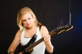 Woman playing on electric guitar and singing