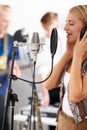 Music, singing and woman with microphone, headphones and band performance with talent. Recording studio, art and happy Royalty Free Stock Photo