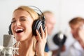 Music, singing and woman with microphone, headphones and band performance with talent. Recording studio, smile and happy Royalty Free Stock Photo