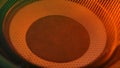 Subwoofer with membrane orange neon light moving vibrating, macro sound bass circles, abstract background.