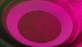 Subwoofer with pink membrane neon light moving vibrating, macro sound bass circles, abstract background.