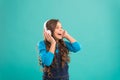 Music sounds better with my headphones. Little girl wearing headphones on blue background. Cute child listening to music Royalty Free Stock Photo