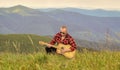 music speaks. sexy man with guitar in checkered shirt. hipster fashion. western camping and hiking. happy and free Royalty Free Stock Photo