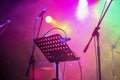 Music stand and microphone at concert stage Royalty Free Stock Photo