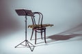 music stand for notes and saxophone on chair Royalty Free Stock Photo