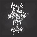 Music is the strongest form of magic - hand drawn Musical lettering phrase isolated on the black chalkboard background