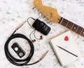 Music stuff. Guitar, guitar pedal, headphone, mobile phone on white background. Top view. Flat lay