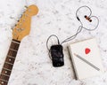 Music stuff. Guitar, guitar pedal, headphone, mobile phone on white background. Top view. Flat lay