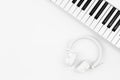 Music Synthesizer Keyboard and white Music headphone, top view. Royalty Free Stock Photo