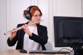 A music teacher conducts a lesson on playing a musical instrument over the Internet. Flute lessons online and online music