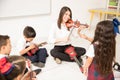 Woman teaching music in preschool Royalty Free Stock Photo