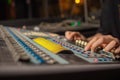 music, technology, people and equipment concept - man at mixing console in sound recording studio over lights. Royalty Free Stock Photo