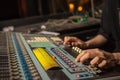 music, technology, people and equipment concept - man at mixing console in sound recording studio over lights. Royalty Free Stock Photo