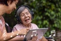 Music therapy in dementia treatment on elderly woman Royalty Free Stock Photo