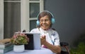 Music therapy in dementia treatment on elderly woman Royalty Free Stock Photo