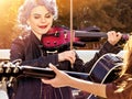 Music on violin by woman perform in park outdoor.