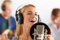 Music, voice and woman with microphone, headphones and band performance with singing talent. Recording studio, art and Royalty Free Stock Photo