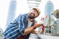 Modern man listening to music using earphones and walking with dog Royalty Free Stock Photo