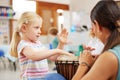 Music is a wonderful way for children to express themselves. a woman teaching a child about musical instruments in class Royalty Free Stock Photo