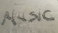 Music word written in sand