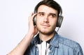 Music! Young man wearing headphones and holding mobile phone. Royalty Free Stock Photo