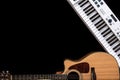 Musical background with acoustic guitar and musical keys on black, copy space. Royalty Free Stock Photo