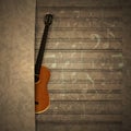 Musical background guitar on old sheet music notation Royalty Free Stock Photo